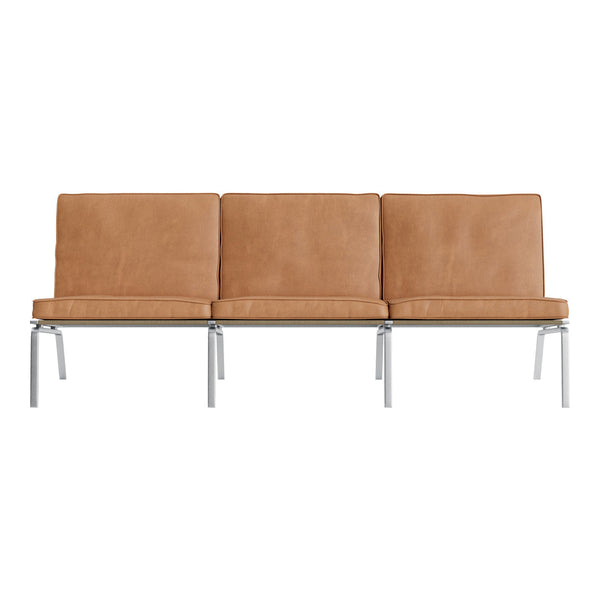 Tan leather sofa with a smooth texture, featuring three cushioned seats and sleek silver metal legs.
