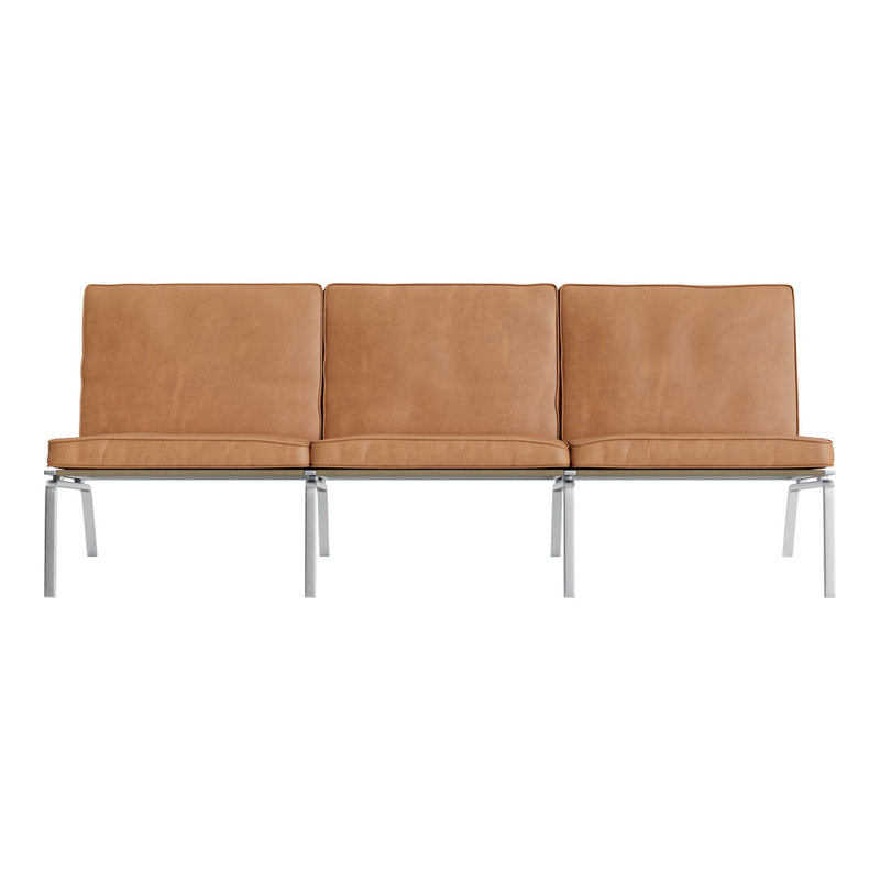 Tan leather sofa with a smooth texture, featuring three cushioned seats and sleek silver metal legs.