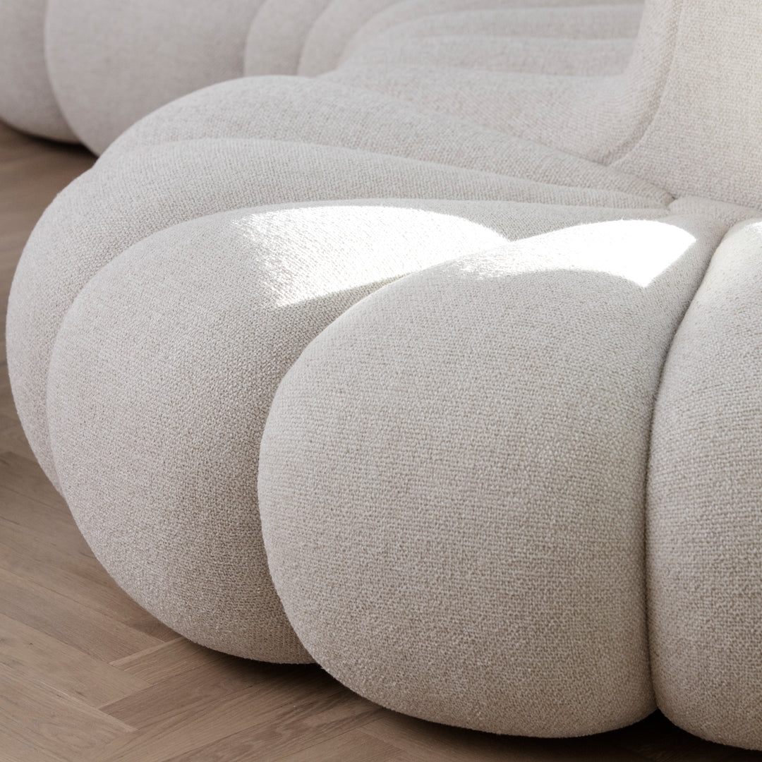 Cream-colored, textured upholstery with a voluminous, plush design for a modern, cozy aesthetic.
