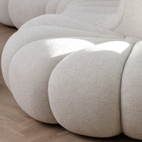 Cream-colored, textured upholstery with a voluminous, plush design for a modern, cozy aesthetic.