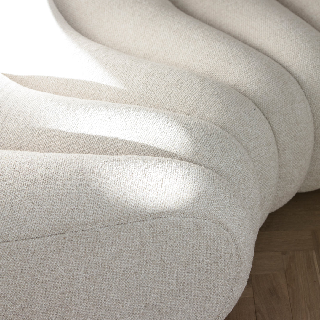 Textured cream fabric with soft curves, featuring a minimalist design and subtle pattern. Perfect for modern interiors.