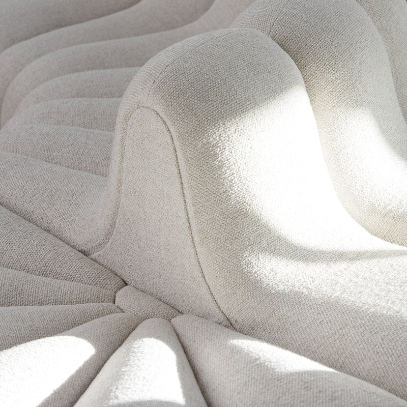 Textured cream fabric with subtle wave pattern, featuring soft curves and play of light and shadow.
