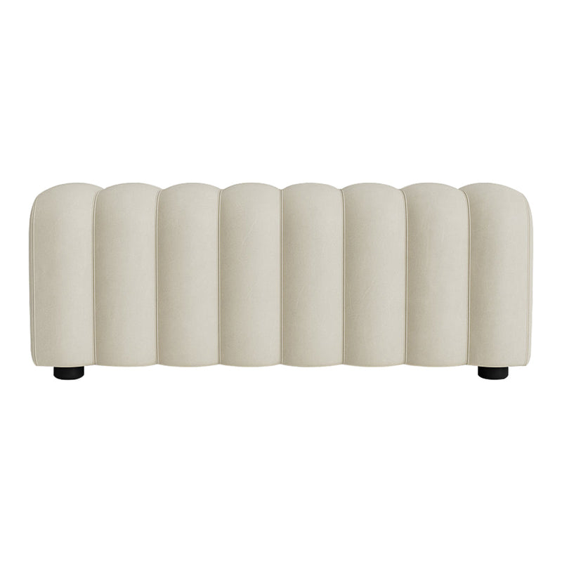 Beige ribbed upholstered bench with soft, curved lines and a contemporary design, perfect for modern living spaces.