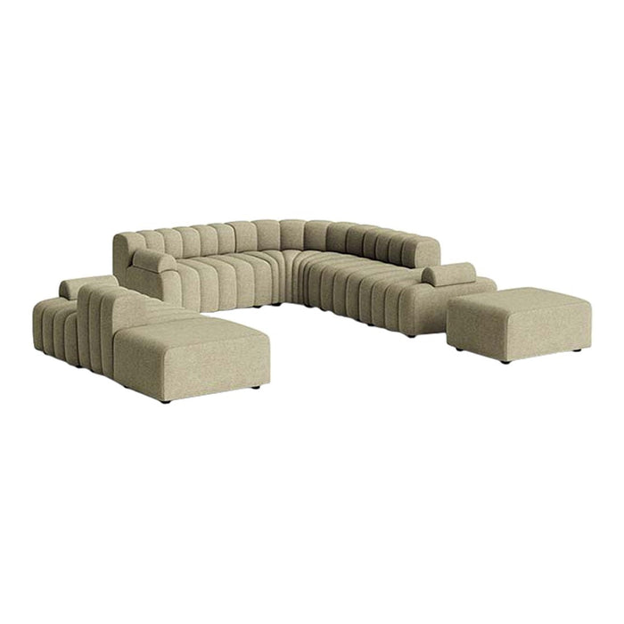 Beige sectional sofa with a modern, curved design and textured fabric pattern, including matching ottoman.
