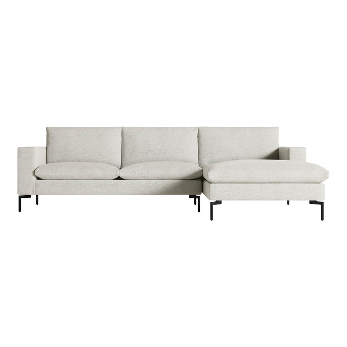 Light gray sectional sofa with simple, modern design and contrasting black metal legs. No patterns, clean lines.