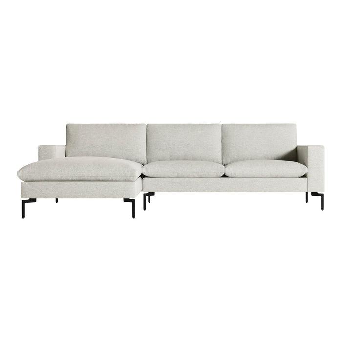 Light gray modern sofa with clean lines and soft cushions, featuring a minimalist design and black metal legs.