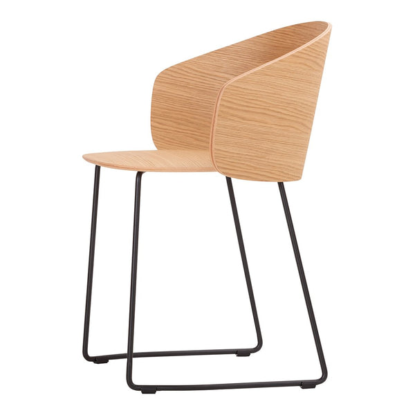 Modern light wood chair with a sleek curved backrest and minimalist black metal legs, perfect for contemporary decor.