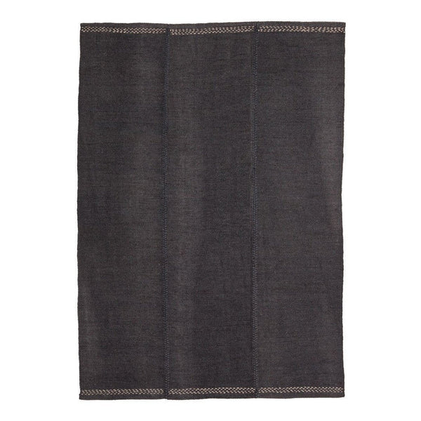 Dark gray textured rug with subtle contrasting stitching, featuring a simple, modern design. Perfect for versatile decor.