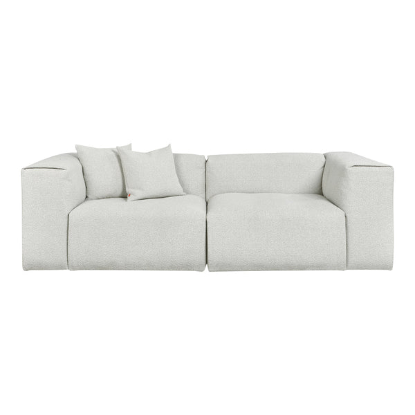 Textured light gray sectional sofa with matching cushions, featuring a minimalist design and soft fabric finish.