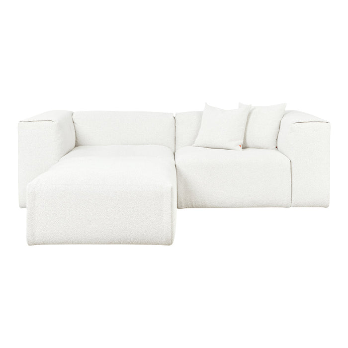 Cozy white sectional sofa with soft, textured fabric and matching throw pillows, ideal for modern living spaces.