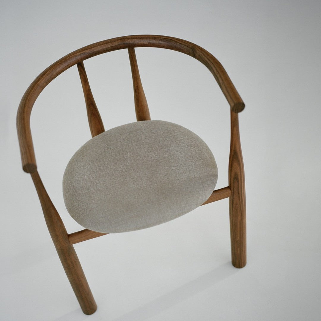 Wooden chair with a gray cushion on a white background