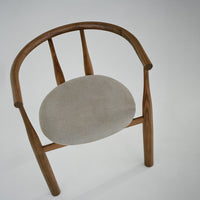 Wooden chair with a gray cushion on a white background