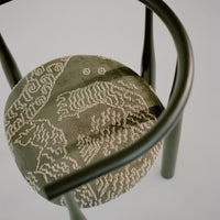Chair with a patterned cushion on a plain background