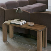 Wooden bench with natural tones, paired with dark purple upholstery and gray tiles for a modern aesthetic.