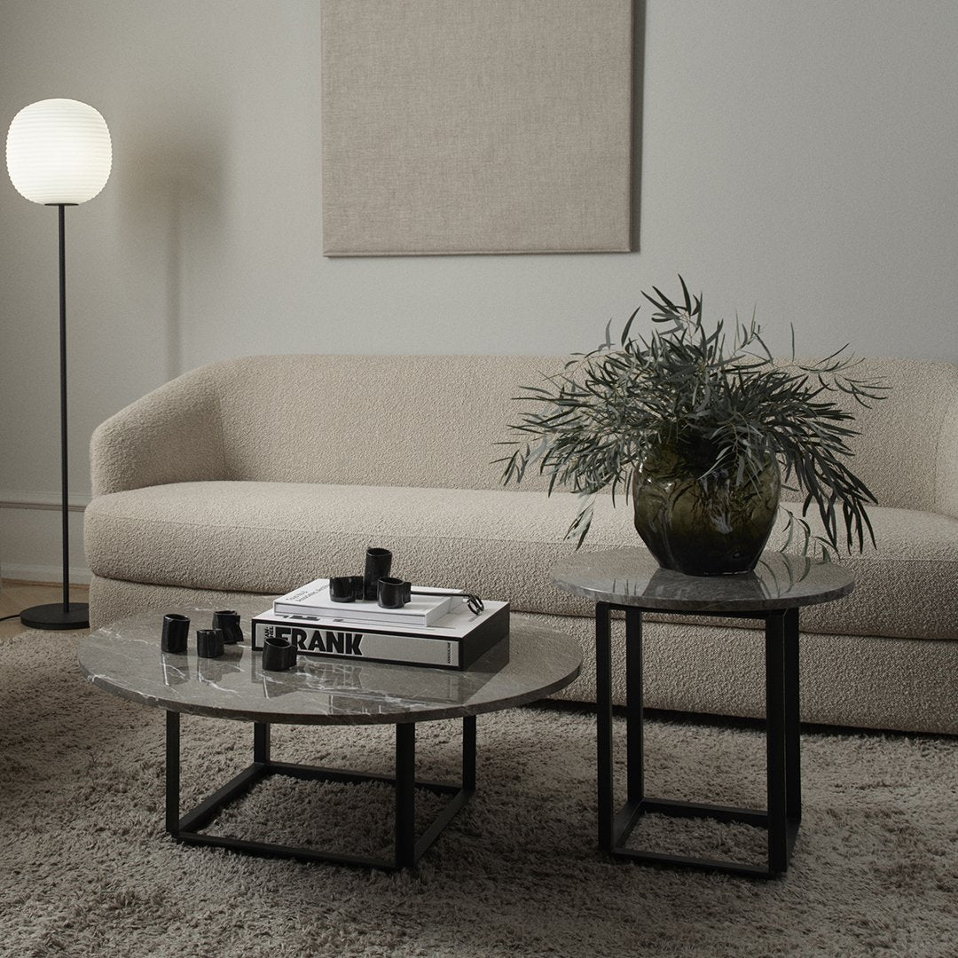 Modern coffee tables with black metal frames and stylish marble tops, featuring subtle gray and white patterns.