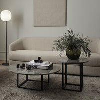 Modern coffee tables with black metal frames and stylish marble tops, featuring subtle gray and white patterns.