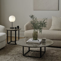 Elegant round coffee table with a marble top, paired with a stylish side table featuring a soft, neutral color palette.
