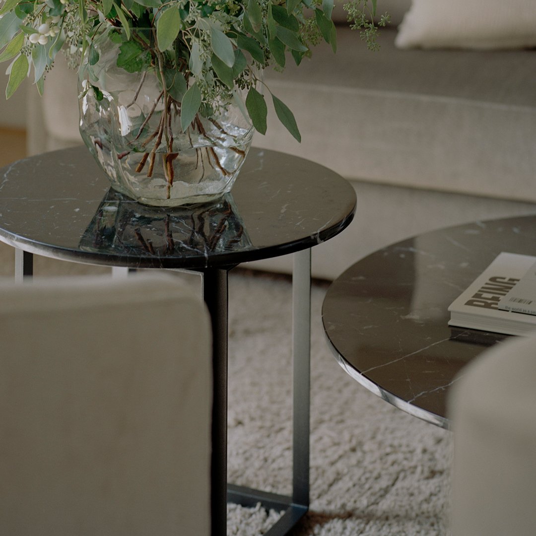 Stylish black marble coffee tables with sleek metal frames, featuring subtle veining patterns for a modern look.