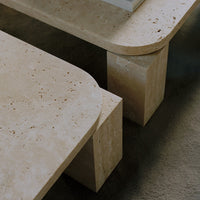 Light beige coffee table with smooth, rounded edges and textured stone pattern. Stylish and modern design.