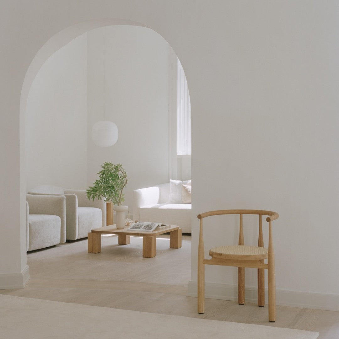 Light, neutral-toned living space with soft textures, natural wood accents, and minimalistic design elements.