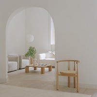 Light, neutral-toned living space with soft textures, natural wood accents, and minimalistic design elements.