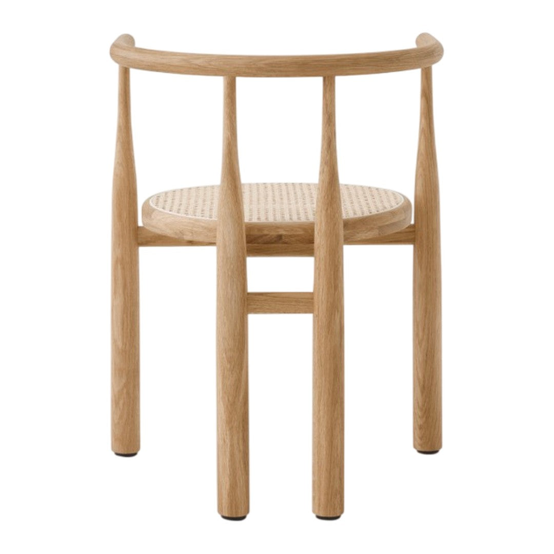 Light oak wood chair with a natural woven seat, featuring a minimalist design and soft, neutral tones.