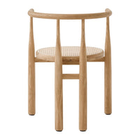 Light oak wood chair with a natural woven seat, featuring a minimalist design and soft, neutral tones.