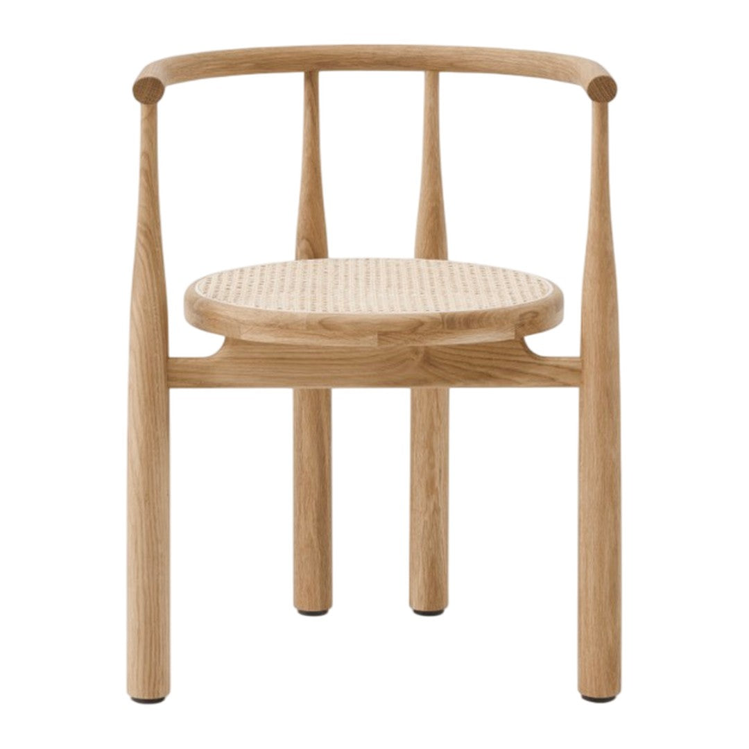 Natural wood chair with a light oak finish and woven cane seat, featuring subtle textures and a minimalist design.