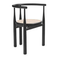 Black chair with sleek lines and a natural woven cane seat design, creating a modern, minimalist aesthetic.