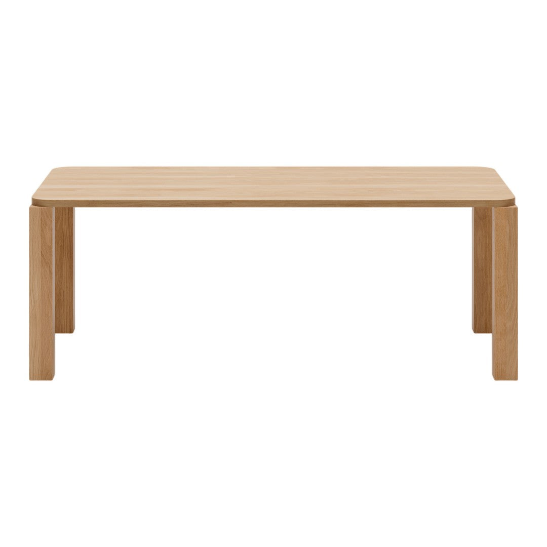 Light oak dining table with a smooth, natural wood grain pattern and minimalist design.