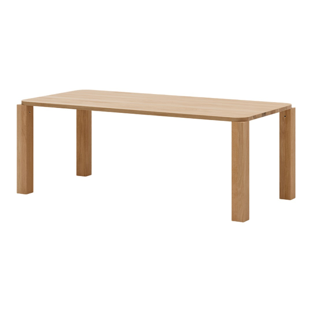 Light oak rectangular table with a smooth surface and minimalist design, featuring natural wood grain patterns.