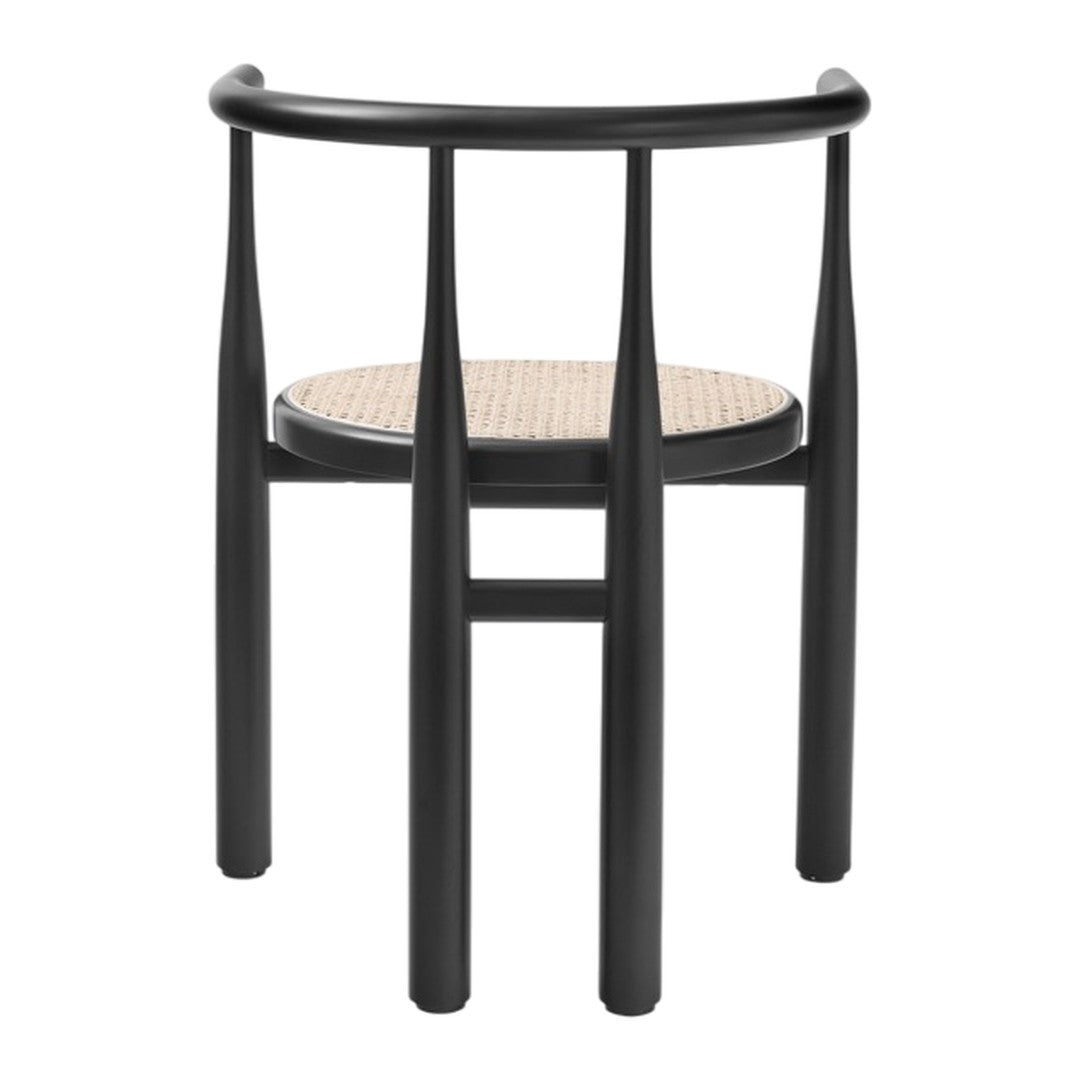 Black chair with slender legs and a natural woven seat, showcasing a stylish modern contrast of colors and textures.