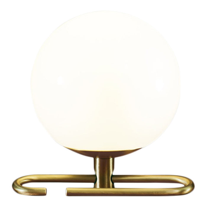 Round white glass lamp with a sleek brass base, featuring a minimalist design and a contemporary aesthetic.