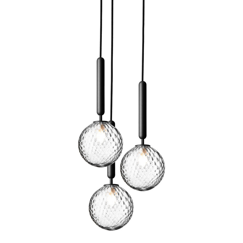 Three glass pendant lights with a textured crystal pattern and sleek black accents, perfect for modern decor.