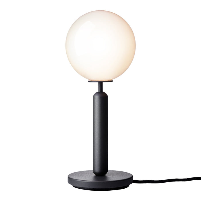 Black base lamp with a smooth white globe shade, featuring a minimalist and modern design.