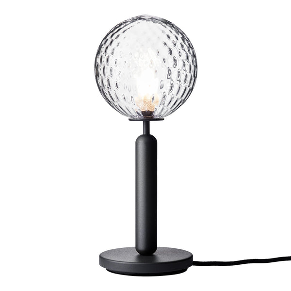 "Textured clear glass lamp with a black metal base and stand, featuring a geometric pattern."