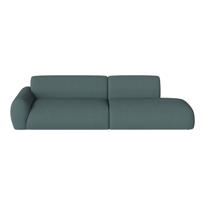 Modern teal sectional sofa with textured fabric and smooth curves, perfect for contemporary living spaces.