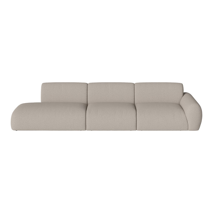 Beige upholstered sectional sofa with a smooth, textured finish, featuring a modern, minimalist design.