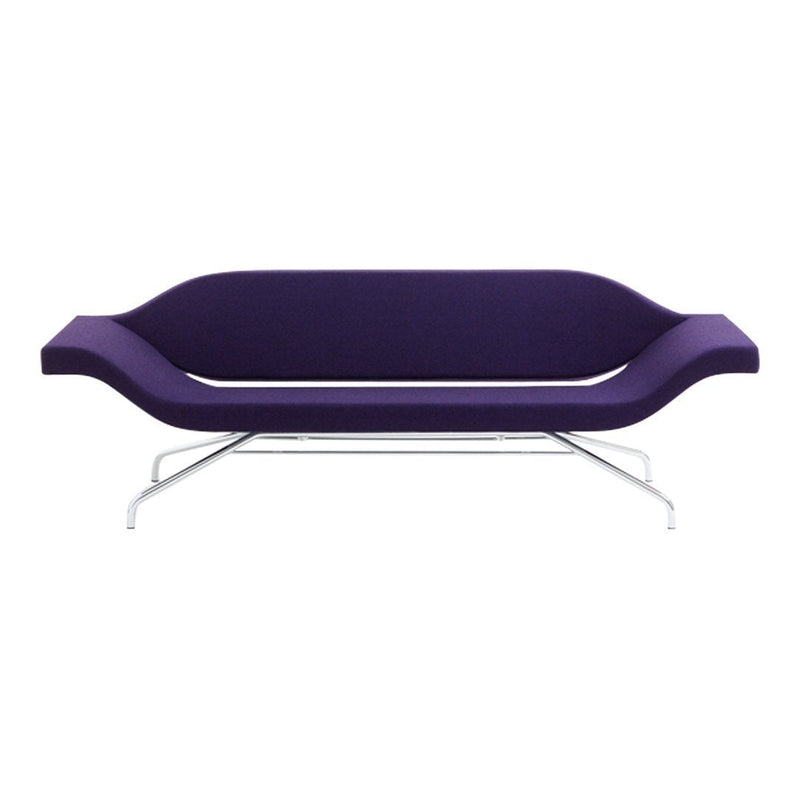 Sleek modern sofa in rich purple upholstery with smooth curves and minimalist silver legs. Perfect for stylish interiors.