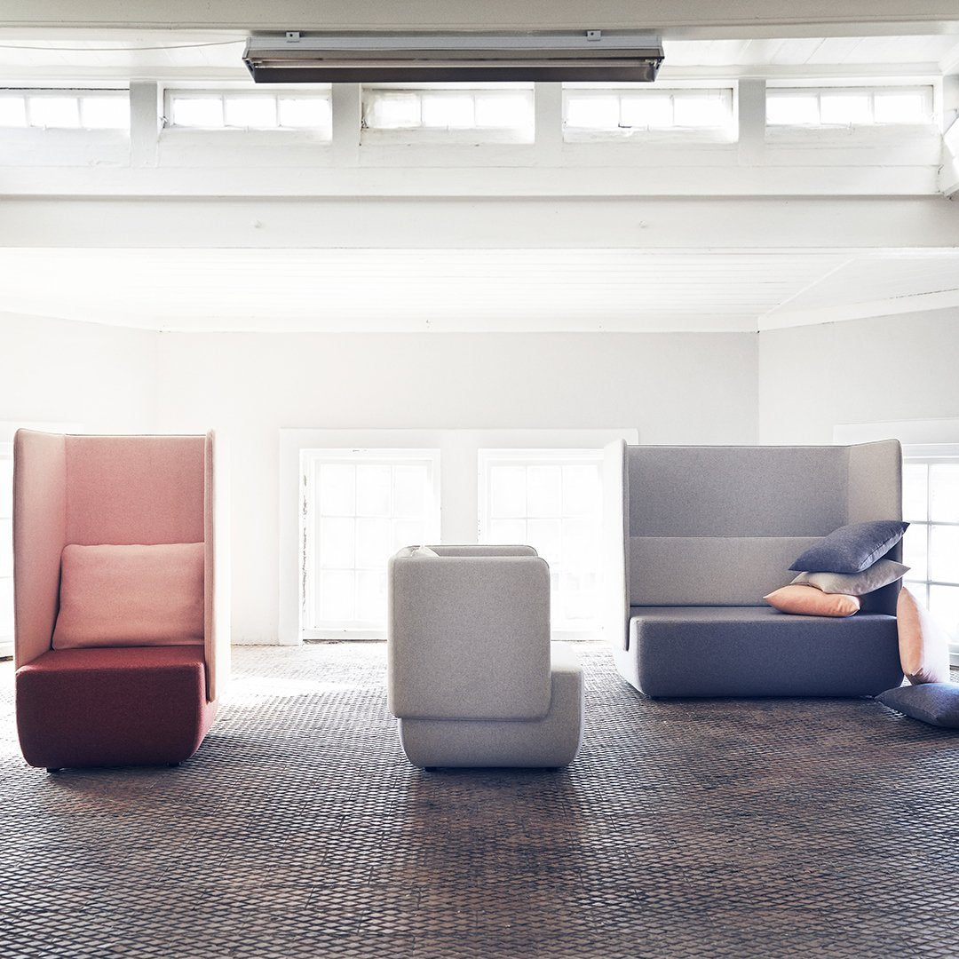 Modern seating in soft pink, gray, and muted tones, featuring geometric patterns and clean lines.