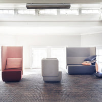 Modern seating in soft pink, gray, and muted tones, featuring geometric patterns and clean lines.