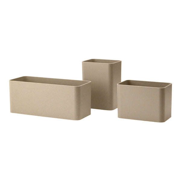Set of three rectangular planters in a soft beige color with a smooth, matte finish. Ideal for minimalist decor.