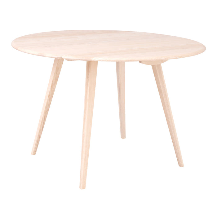 Light wood round table with a smooth, natural finish and angled legs, featuring a minimalist design.