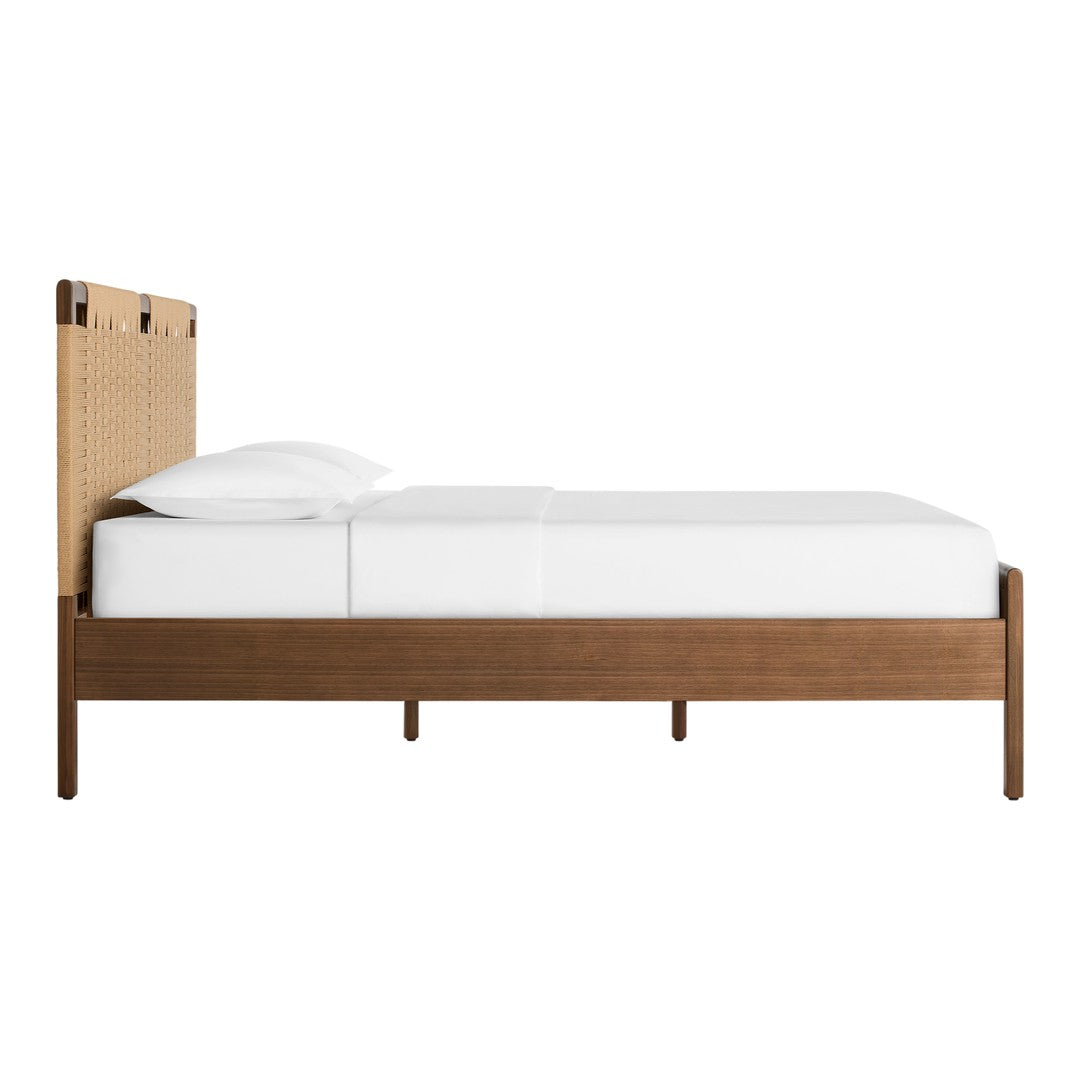 Wooden bed frame with a natural rattan headboard, cream white bedding, and warm brown tones. Minimalist design.