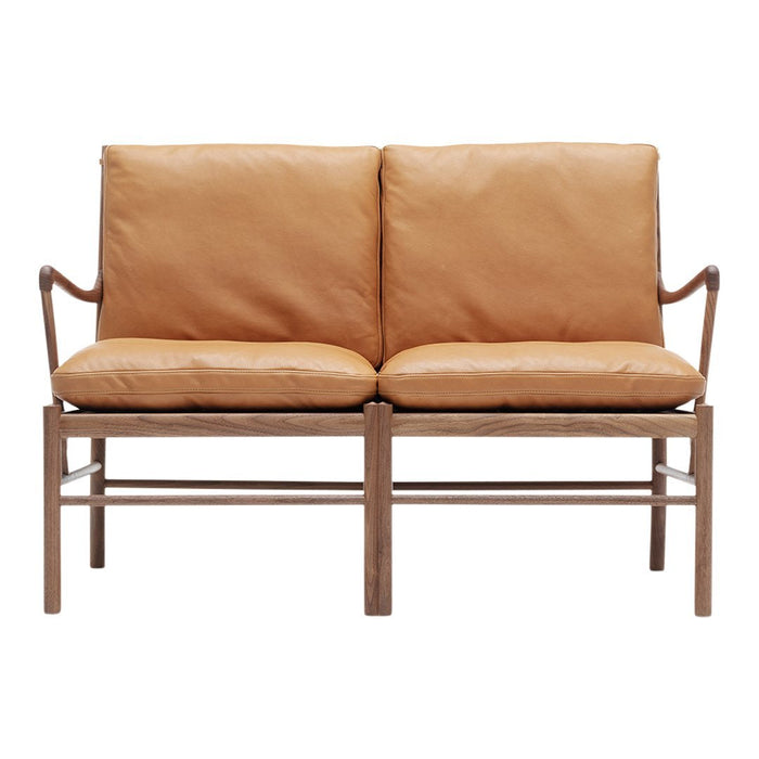 Tan leather loveseat with a natural wood frame and simple, sleek design. Perfect for modern decor.