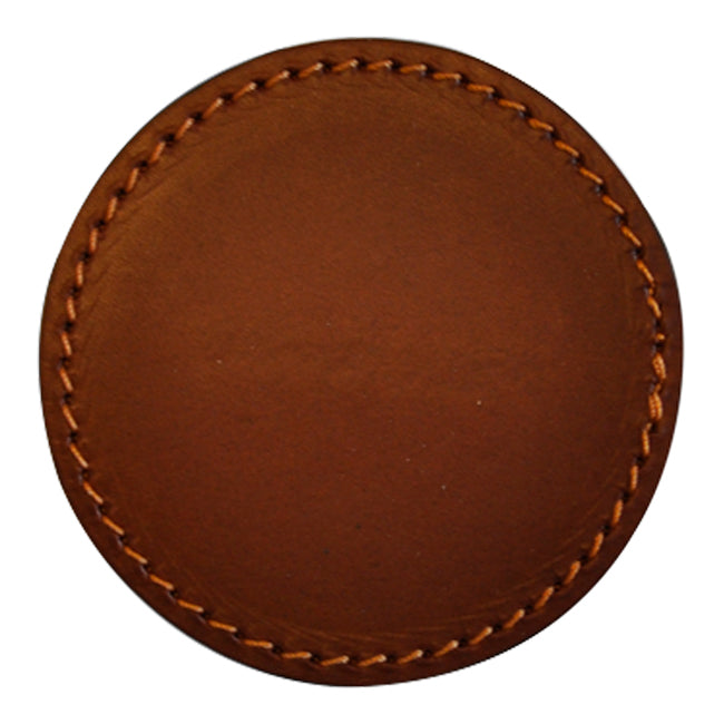 Round leather coaster in warm brown with subtle texture and contrasting golden stitching. Perfect for any table setting.