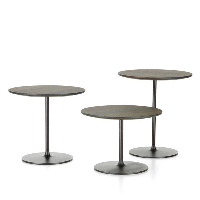 Set of three modern round side tables in matte black and bronze finishes with sleek bases and smooth surfaces.