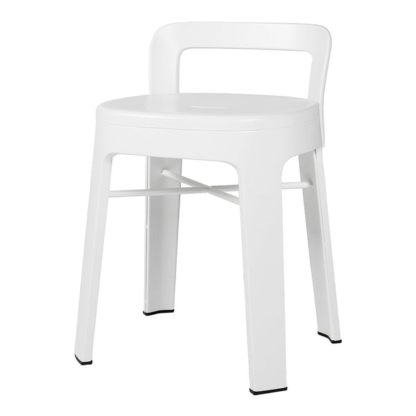 White plastic chair with sleek, modern design and contrasting black feet accents, perfect for minimalist spaces.