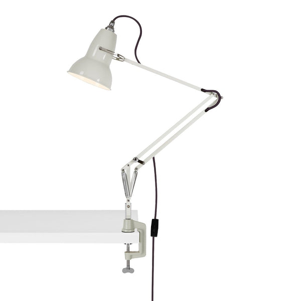 White clamp lamp with an adjustable arm and sleek, minimalist design, perfect for modern decor.