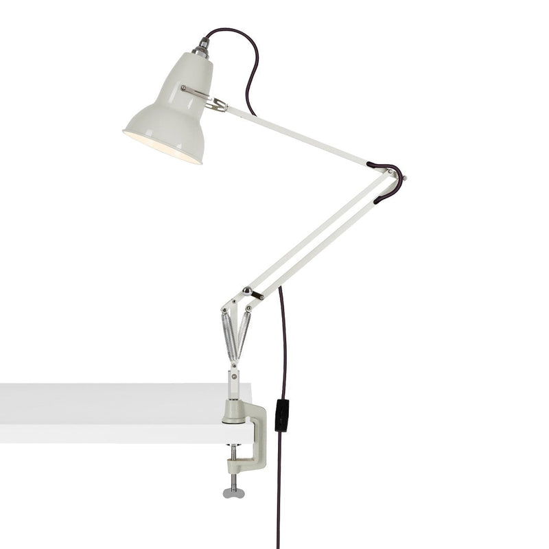 White clamp lamp with an adjustable arm and sleek, minimalist design, perfect for modern decor.